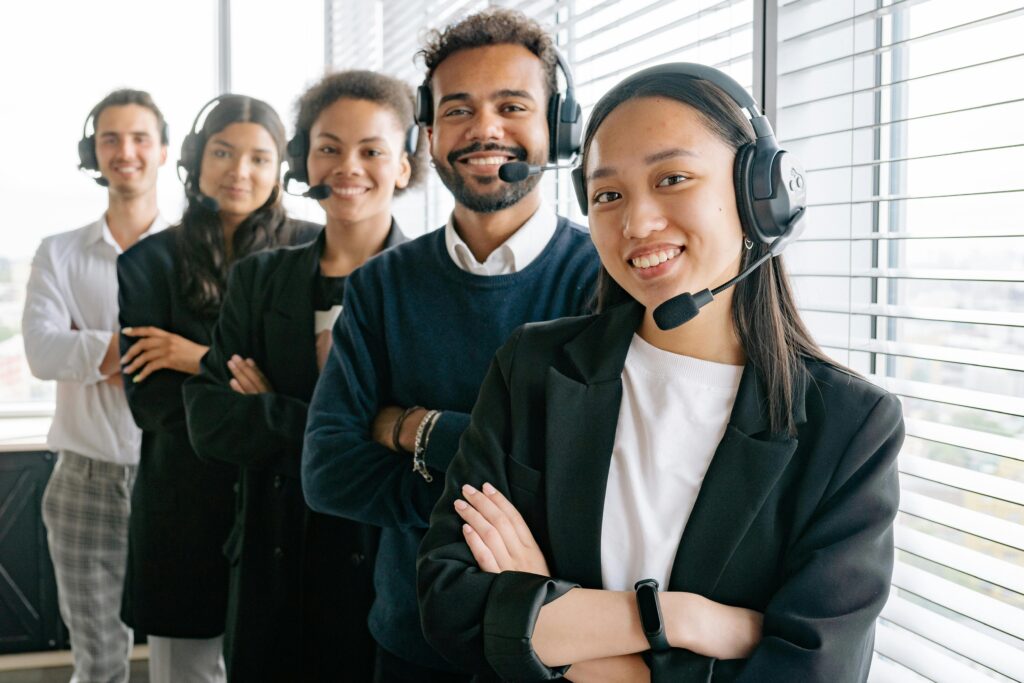 AI for Customer Service - 5 agents smiling with headphones